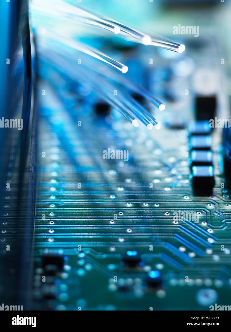 Digital communication, conceptual image. Fibre optics carrying data passing across a computer's motherboard. Stock Photo