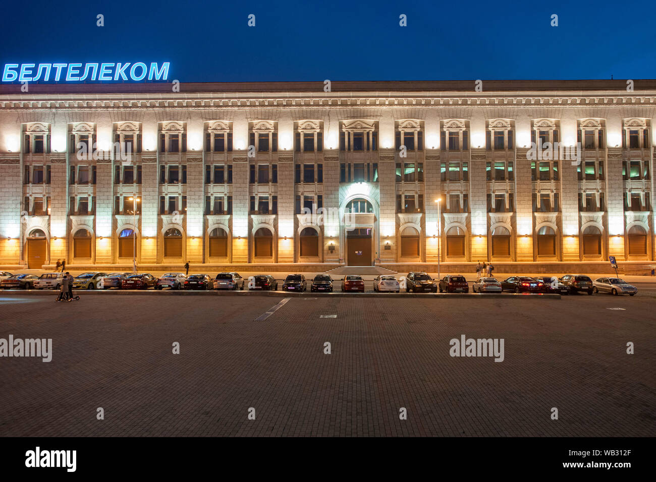 Night view of a building overlooking October Square in Minsk, Belarus. Stock Photo