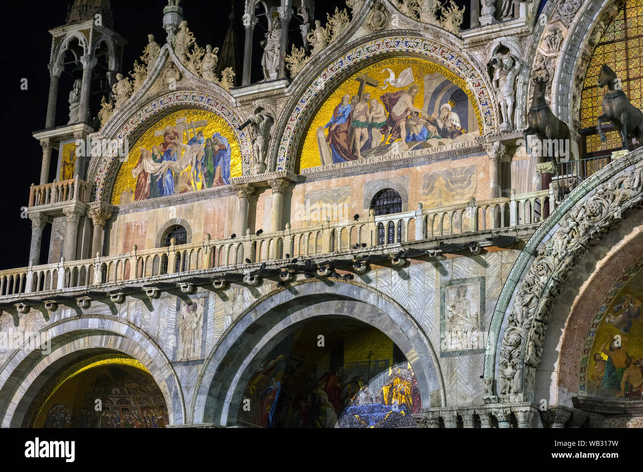 Mosaics on the west façade of the Basilica di San Marco (St Mark's Basilica) at night.  Saint Mark's Square, Venice, Italy Stock Photo