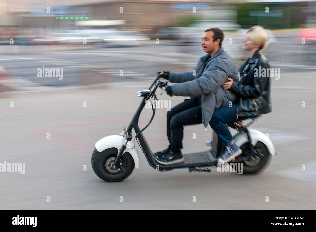 Couple on an electric scooter in Minsk, Belarus. Stock Photo