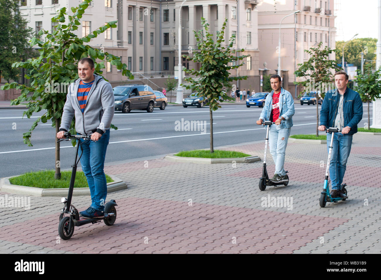 Men on electric scooters in Minsk, Belarus. Stock Photo