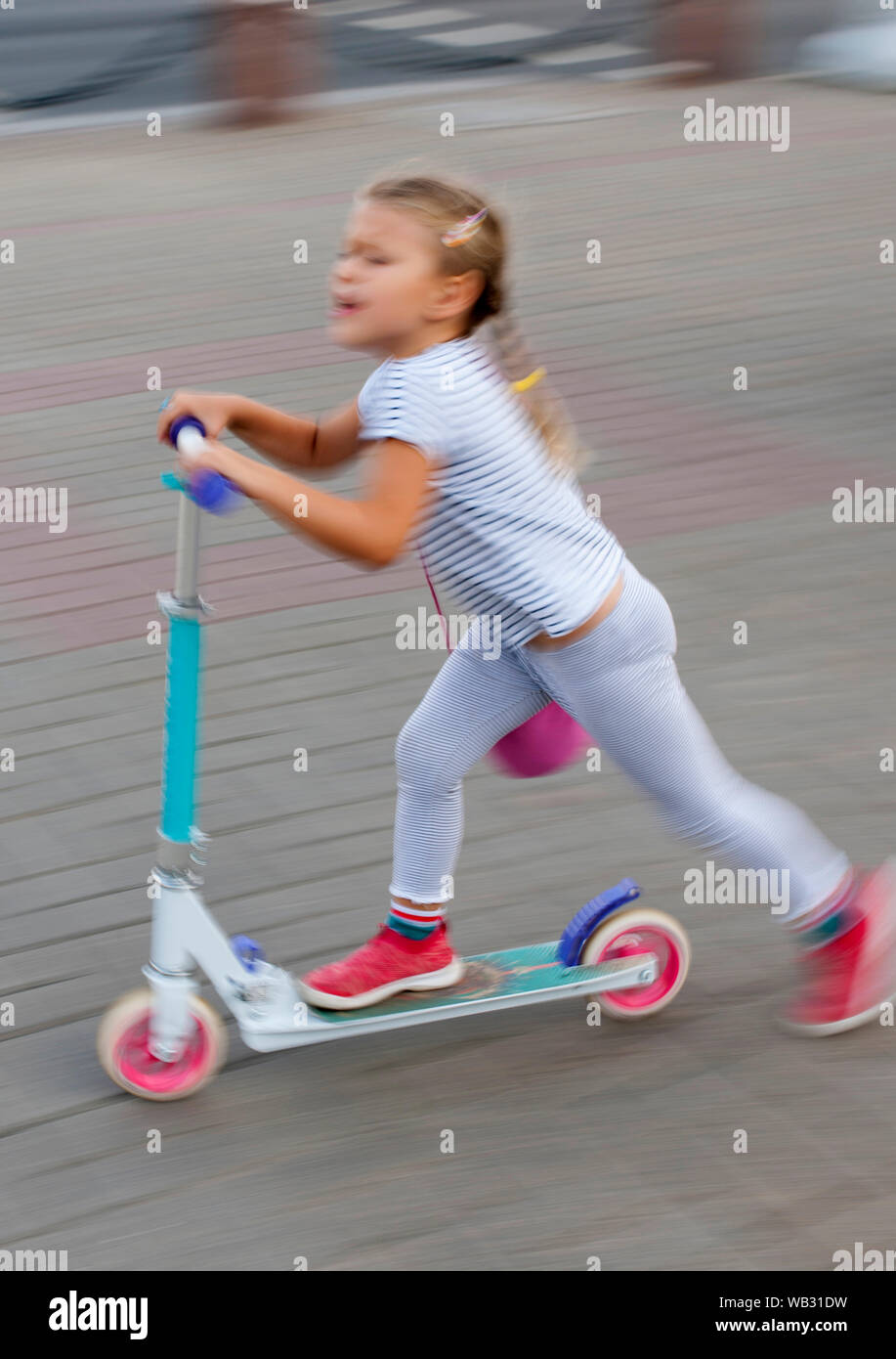 Young girl on a scooter in Minsk, Belarus. Stock Photo