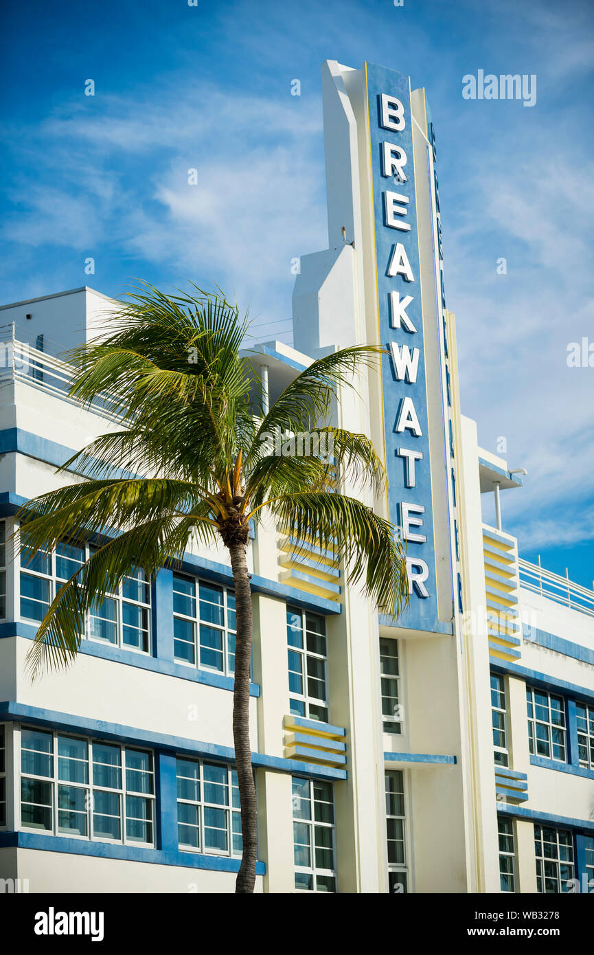 MIAMI - SEPTEMBER 15, 2018: A palm tree complements the Streamline Moderne architectural style of the Art Deco Breakwater Hotel on Ocean Drive. Stock Photo