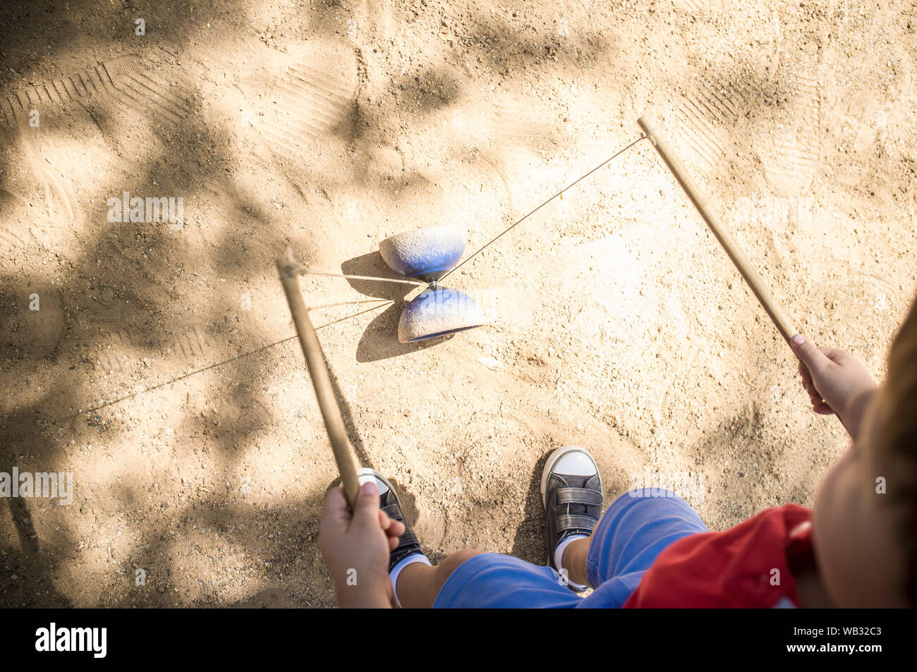 Little boy learning to use diabolo i the park. Classic games for children concept Stock Photo