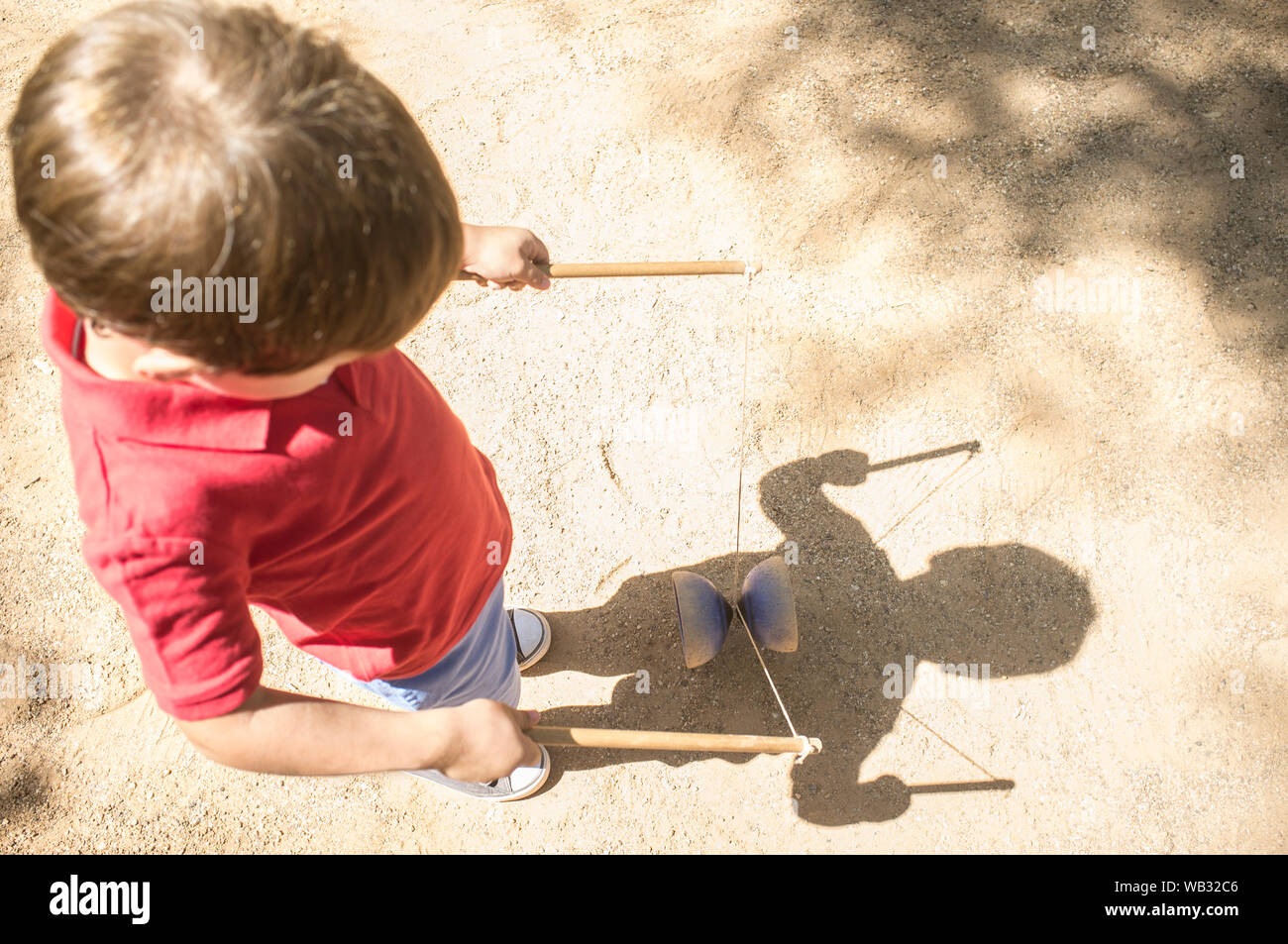 Little boy learning to use diabolo i the park. Classic games for children concept Stock Photo
