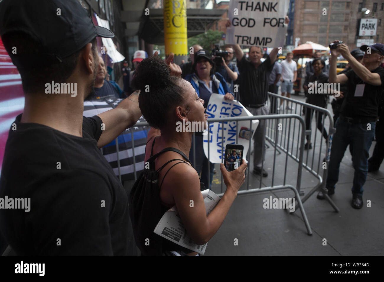 August 13, 2019: Demonstrators are shown protesting against Greyhound Corporation and ICE (Immigration Customs and Enforcement) and confronting anti-protestors and Trump supporters at the Port Authority Bus Terminal on 42nd and 8th Avenue in New York, New York. About 100 activists from a coalition of groups including FIRE (Fight For Immigrant Refugees Everywhere) protested Greyhound allowing ICE agents to board their busses 'searching for migrants,'' officials said. Credit: Brian Branch Price/ZUMA Wire/Alamy Live News Stock Photo