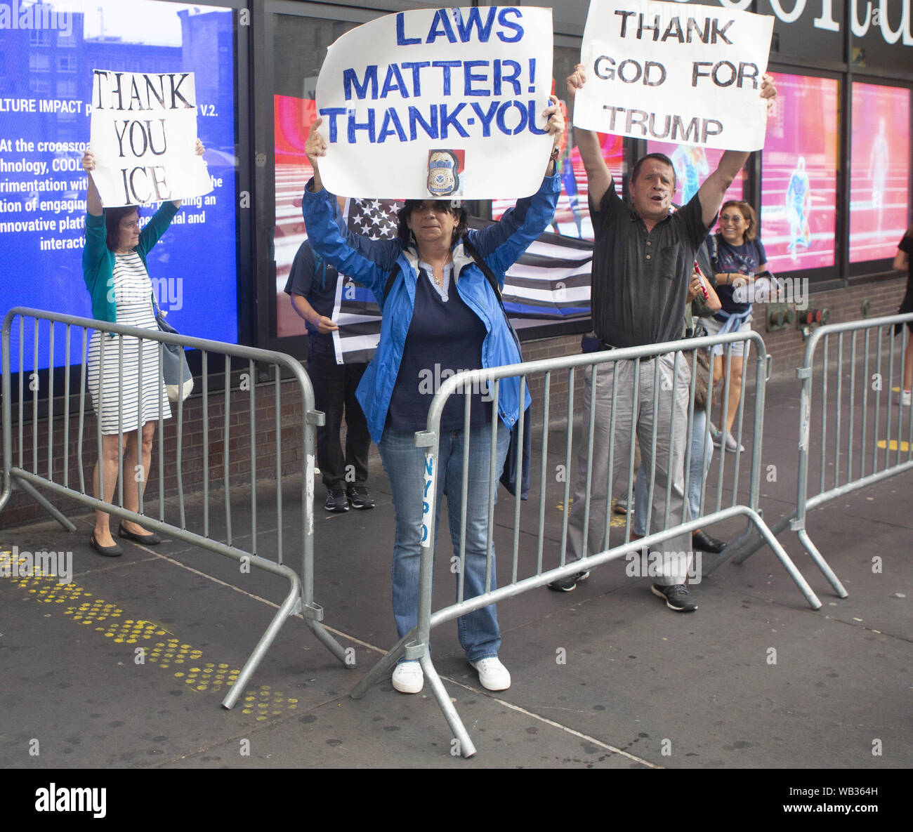 August 23, 2019: Trump Supporters and anti-protestors appear during a protest against Greyhound Corporation and ICE (Immigration Customs and Enforcement) at the Port Authority Bus Terminal on 42nd and 8th Avenue in New York, New York. About 100 activists from a coalition of groups including FIRE (Fight For Immigrant Refugees Everywhere) protested Greyhound allowing ICE agents to board their busses 'searching for migrants,'' officials said. Credit: Brian Branch Price/ZUMA Wire/Alamy Live News Stock Photo