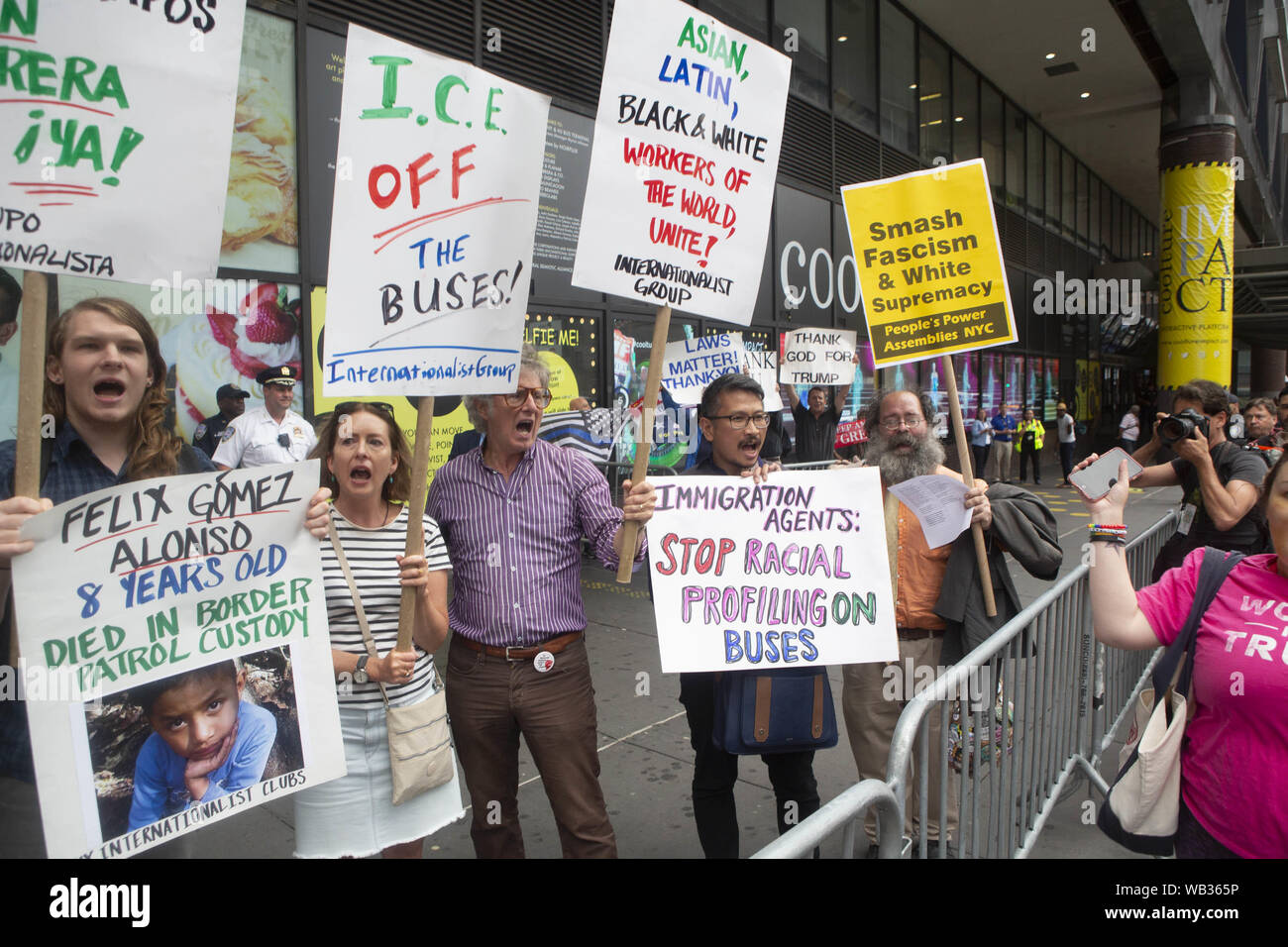 August 23, 2019: Demonstrators are shown during a protest against Greyhound Corporation and ICE (Immigration Customs and Enforcement) at the Port Authority Bus Terminal on 42nd and 8th Avenue in New York, New York. About 100 activists from a coalition of groups including FIRE (Fight For Immigrant Refugees Everywhere) protested Greyhound allowing ICE agents to board their busses 'searching for migrants,'' officials said, .Far right are Anti-demonstrators and Trump supporters Credit: Brian Branch Price/ZUMA Wire/Alamy Live News Stock Photo