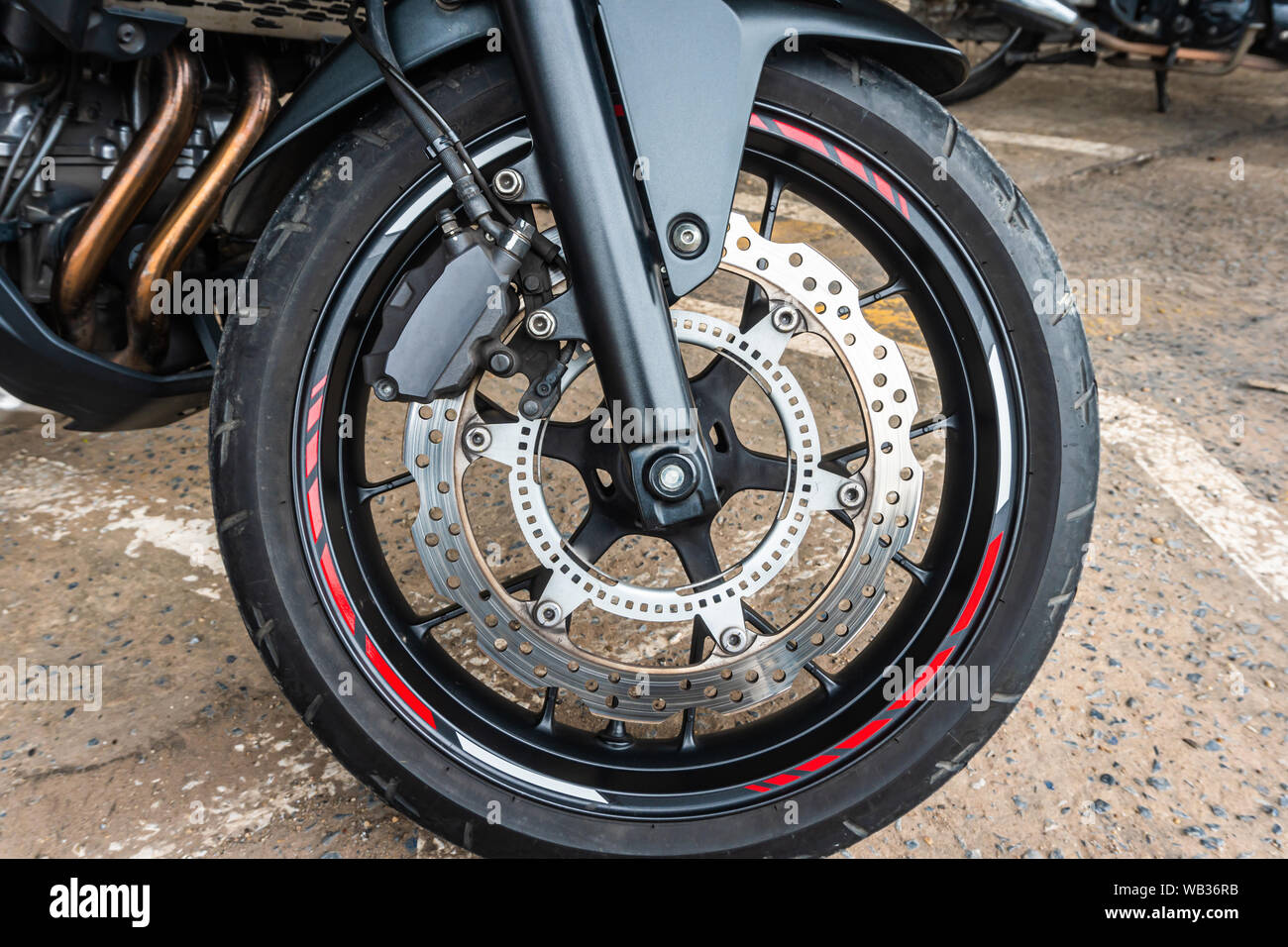 Front wheel close up of brakes system in a modern motorcycle modern