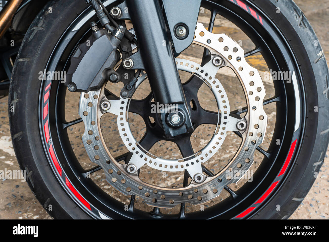 Front wheel close up of brakes system in a modern motorcycle modern