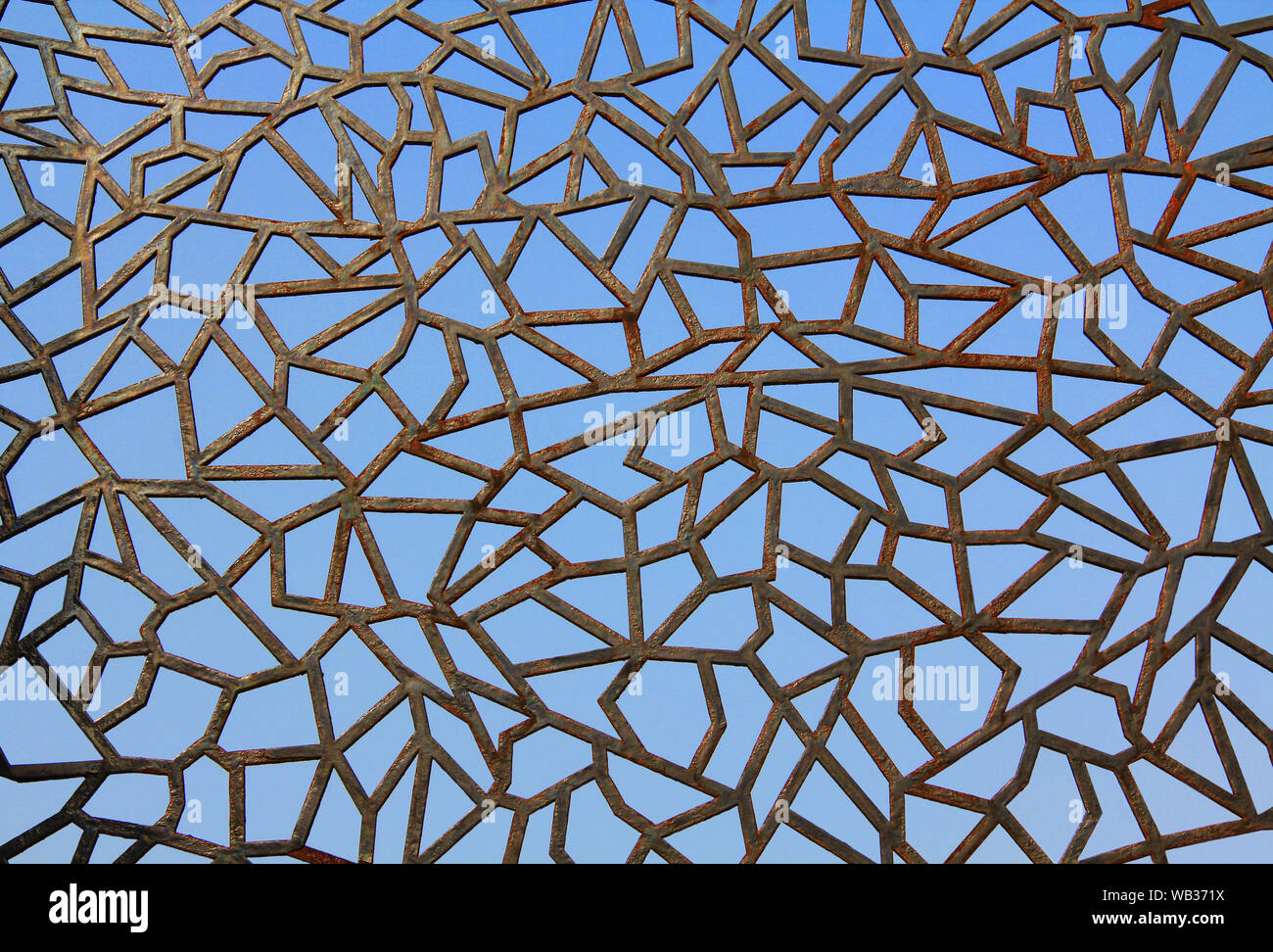 Close-up of Abstract Metal Fence Against a Blue Sky Stock Photo