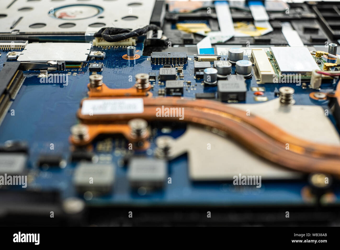Technician repairing broken laptop notebook computer with screwdriver Stock Photo