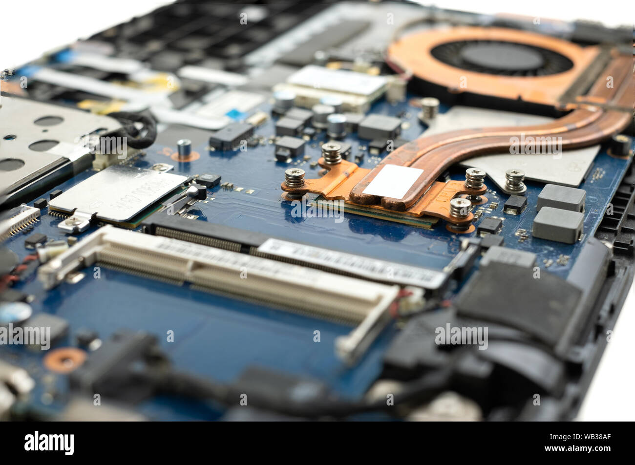 Technician repairing broken laptop notebook computer with screwdriver Stock Photo