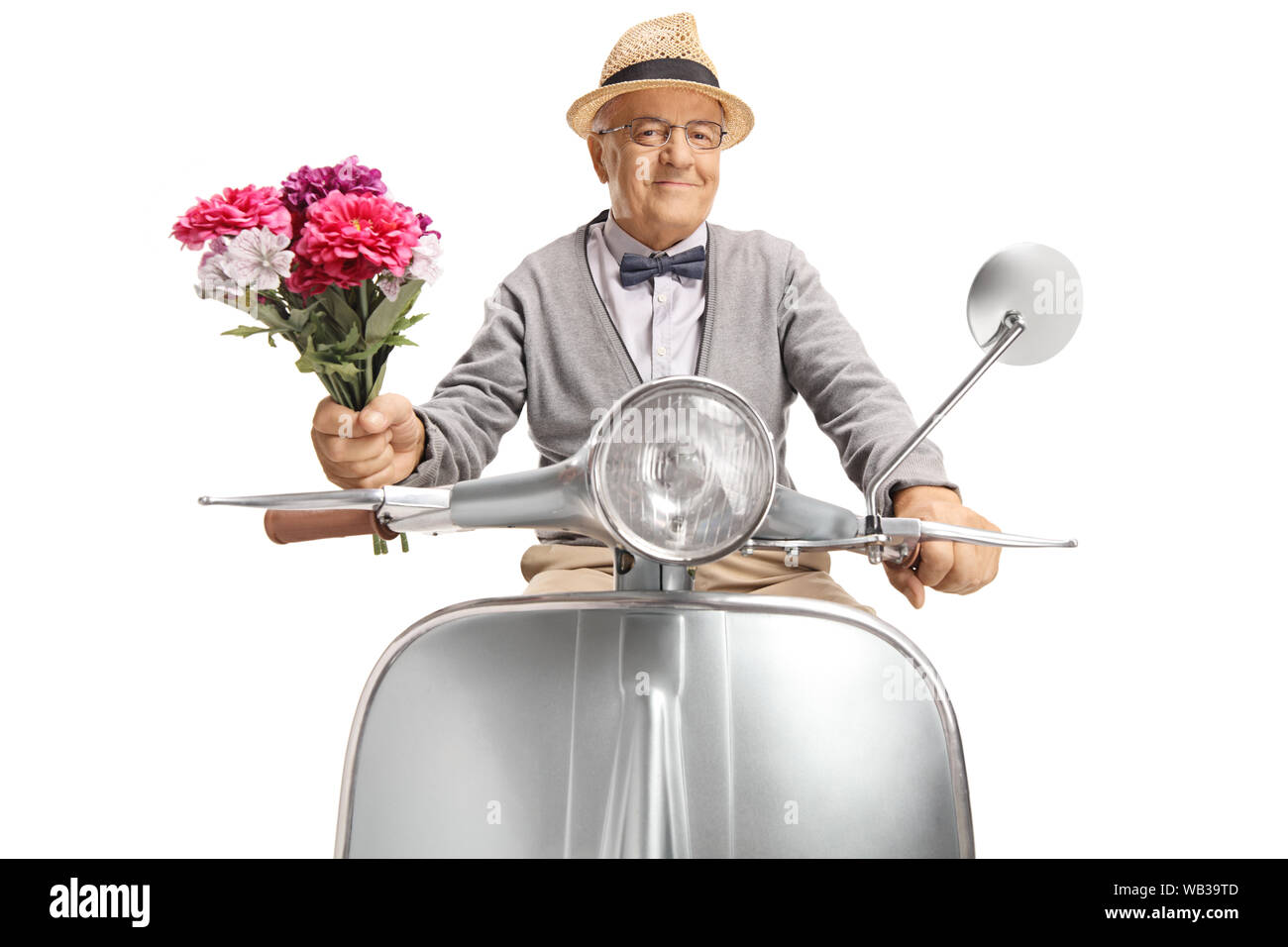 Elderly gentleman on a motorbike holding a bunch of flowers isolated on white background Stock Photo