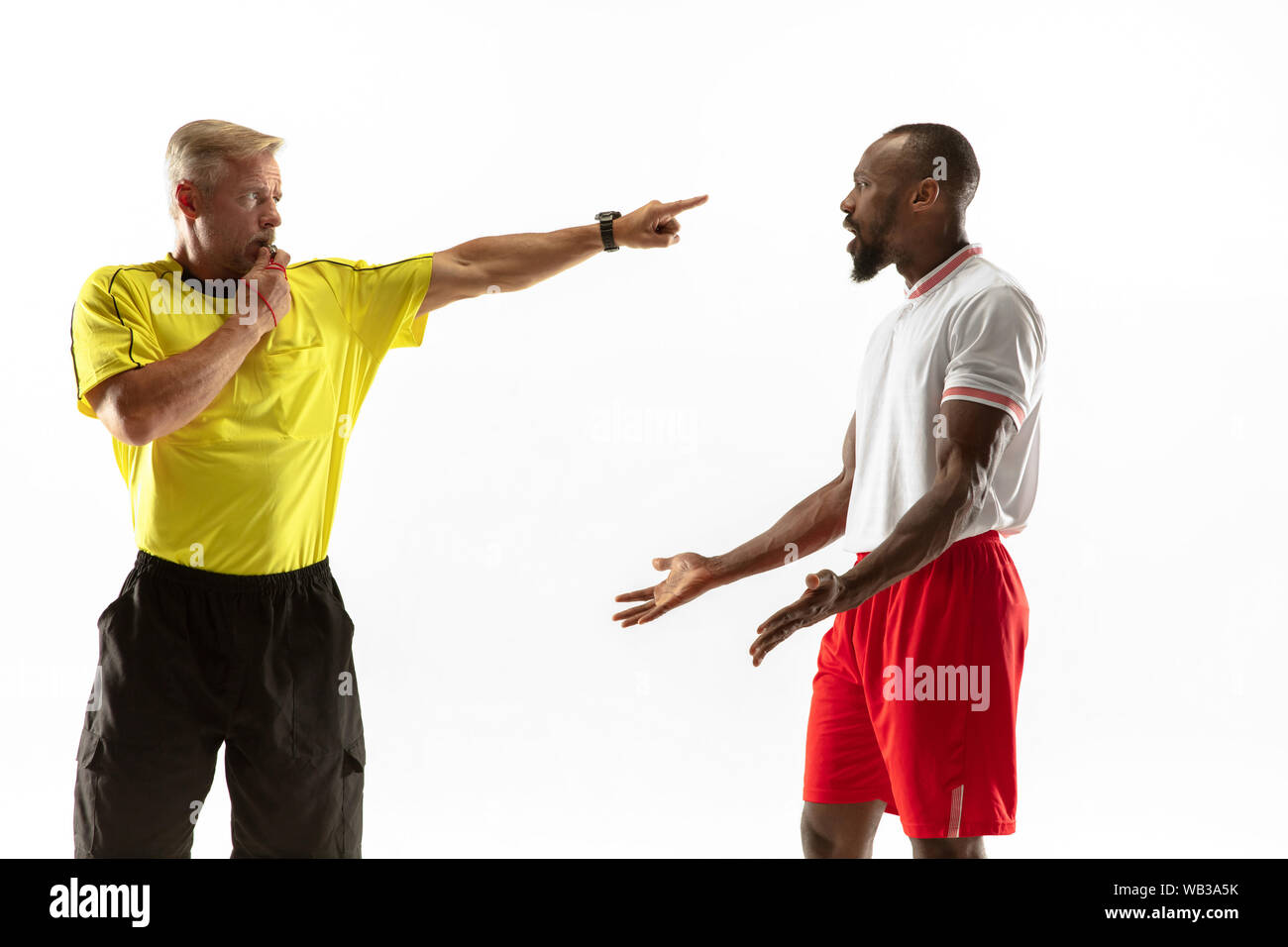 Free Photo  Referee holding ball and showing a red card to a football or  soccer player while gaming on white studio background.