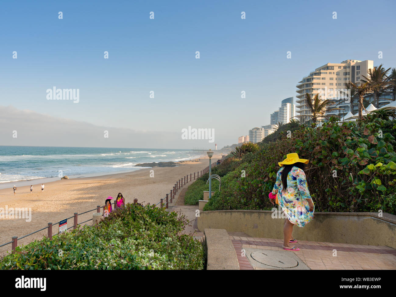 DURBAN SOUTH AFRICA - AUGUST 23 2019: Woman in colorful clothing on the promenade at the beach in Umhlanga Rocks near Durban KwaZulu-Natal South Afric Stock Photo