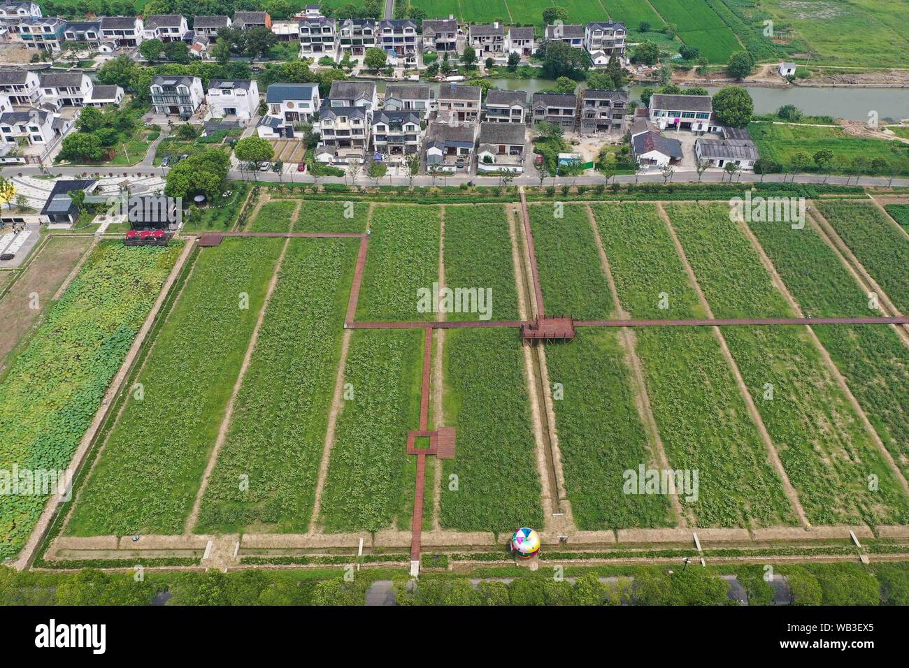 Kunshan. 23rd Aug, 2019. Aerial photo taken on Aug. 23, 2019 shows a view of a village in Zhouzhuang Township of Kunshan City in east China's Jiangsu Province. Rural revitalization strategy has been implemented in Kunshan city in recent years to achieve the basic modernization of agriculture and rural areas. Credit: Ji Chunpeng/Xinhua/Alamy Live News Stock Photo