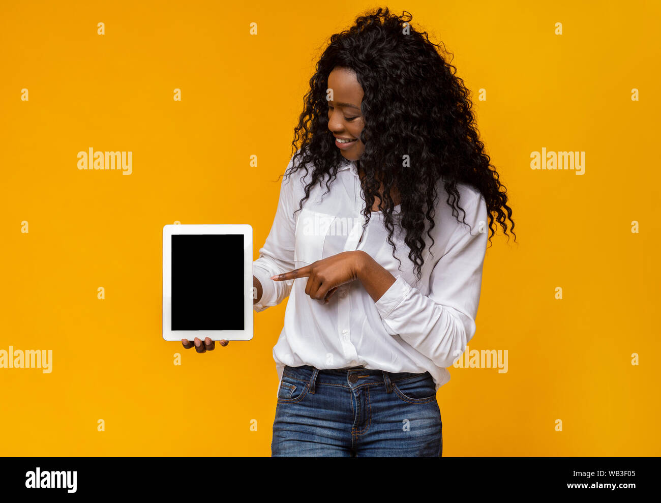 Black woman pointing at blank digital tablet screen Stock Photo - Alamy