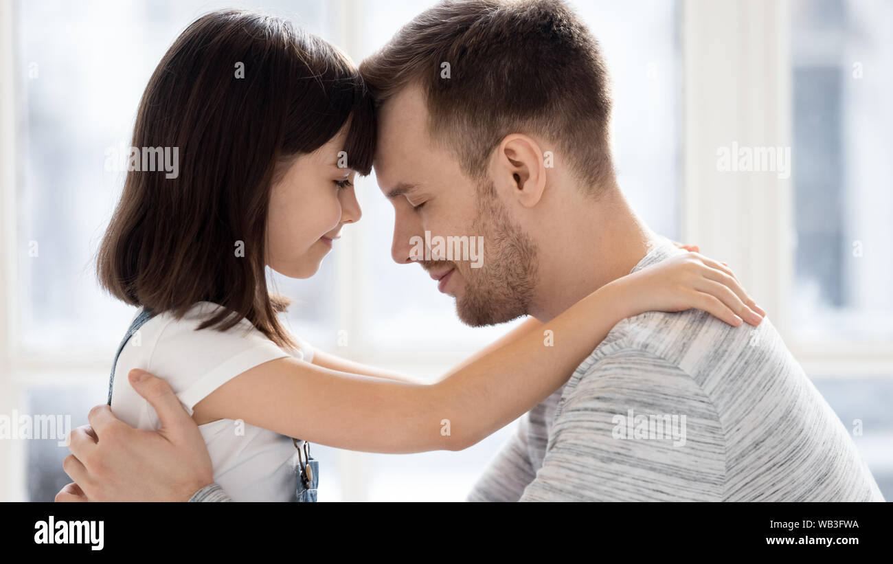 Happy single dad and cute small child daughter bonding embracing Stock Photo