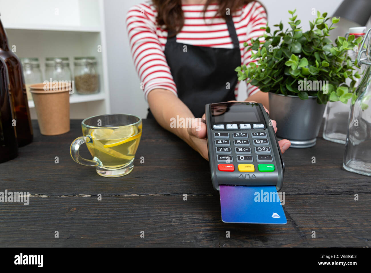 Customer making wireless or contactless payment using credit card Stock Photo