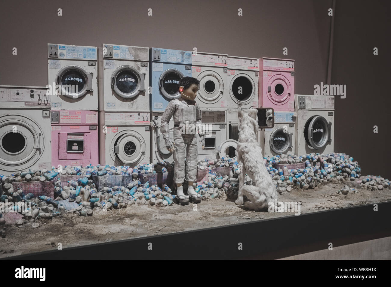 Boy and dog at laundromat in front of abandoned washing machines, on display in London at the Isle of Dogs exhibition, directed by Wes Anderson – Marc Stock Photo