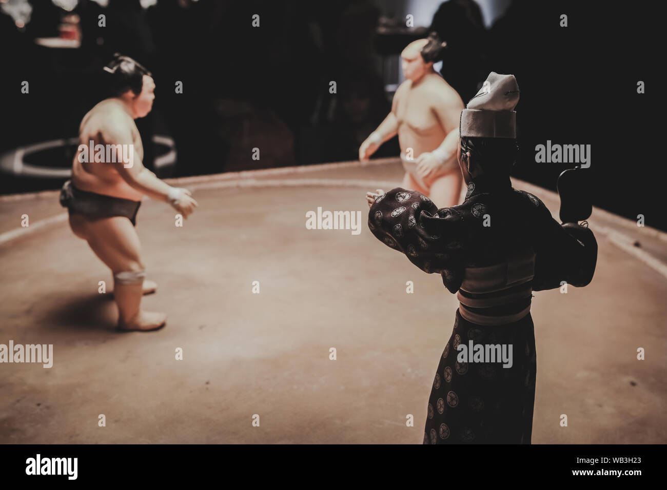 Sumo wrestlers and judge, referee, on display in London at the Isle of ...