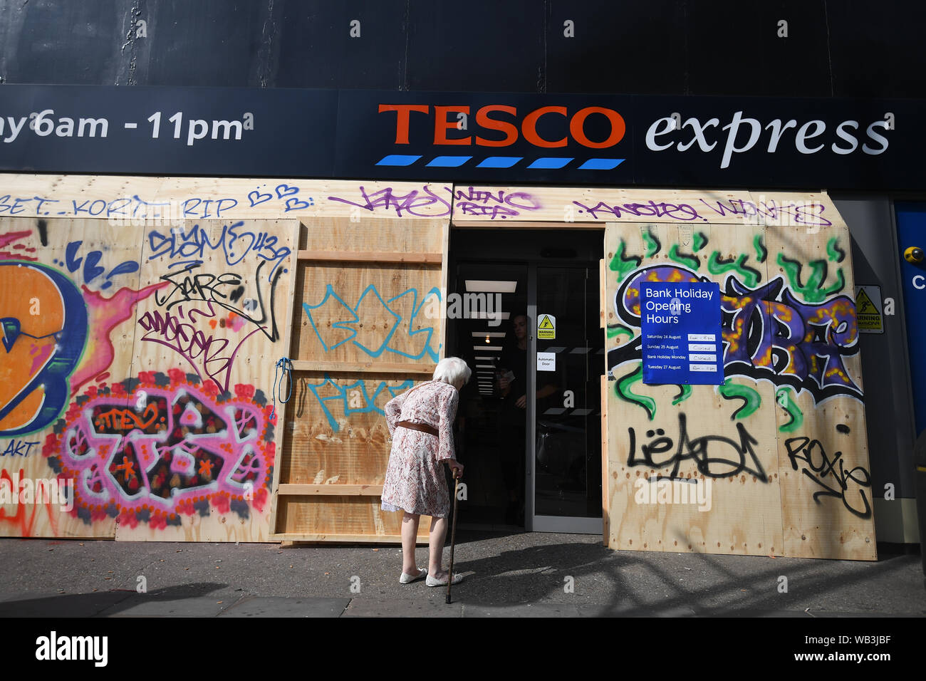 A Tesco Express windows are boarded up in preparation for the Notting Hill Carnival in west London. Stock Photo