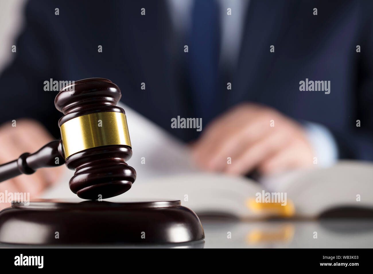 Attorney at law with antique wooden mallet. Legal counsel office. Place