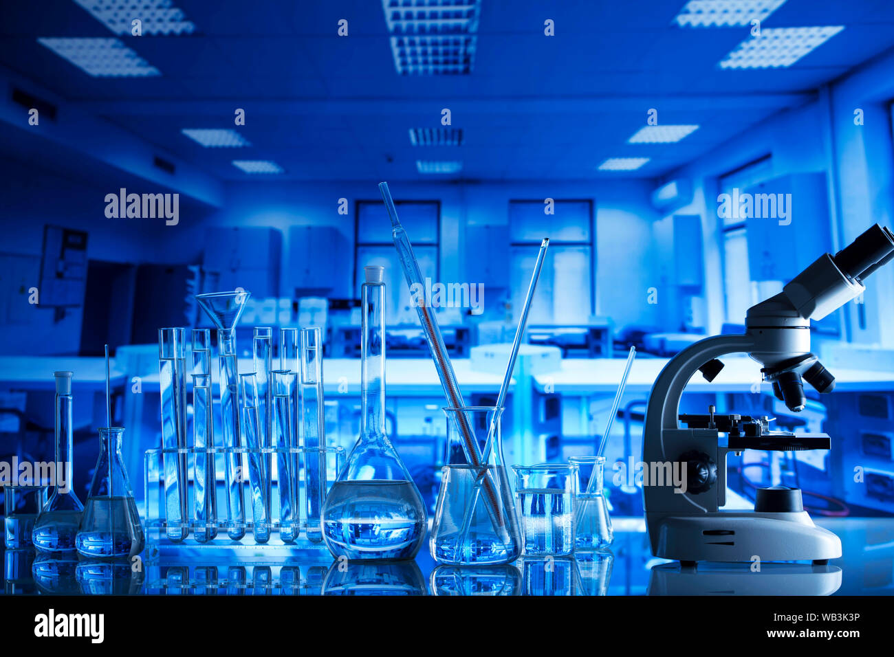 Science laboratory concept background. Microscope and laboratory glassware  composition Stock Photo - Alamy