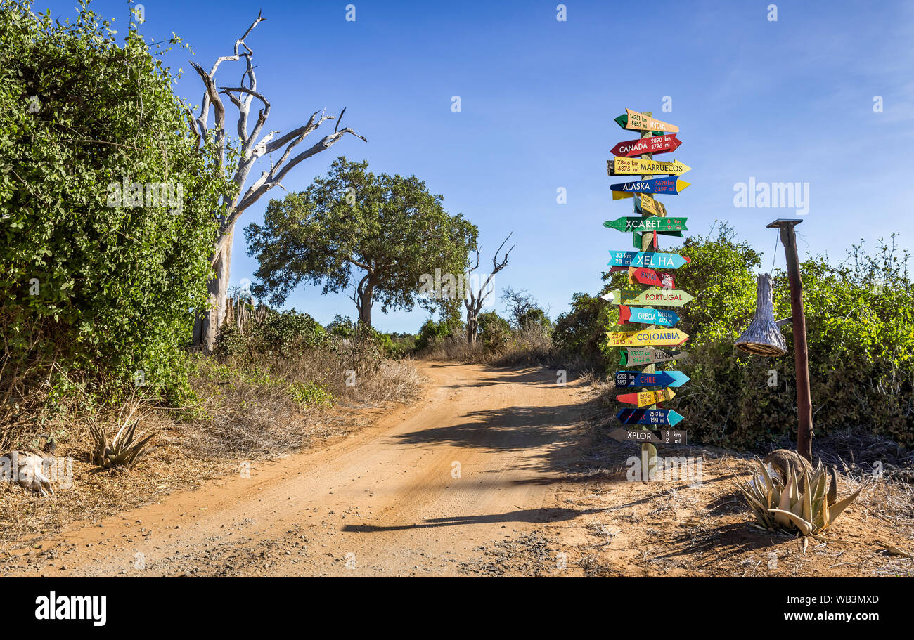 Funny different world directions signpost with distance to many different countries Stock Photo