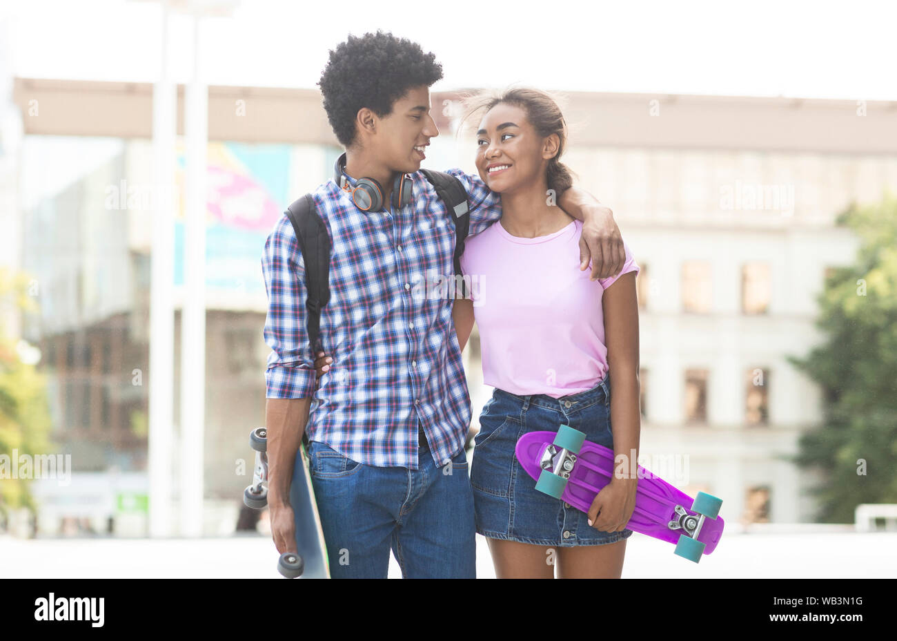 Teens dating in the city walking together outdoors Stock Photo