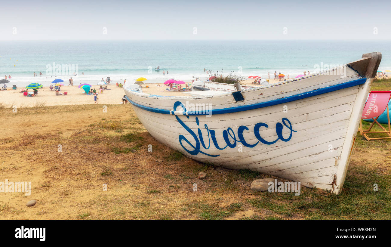 Old fishing boat advertising Sirocco Restaurant at Bolonia beach, Bolonia, Costa de la Luz, Cadiz Province, Andalusia, southern Spain. Stock Photo