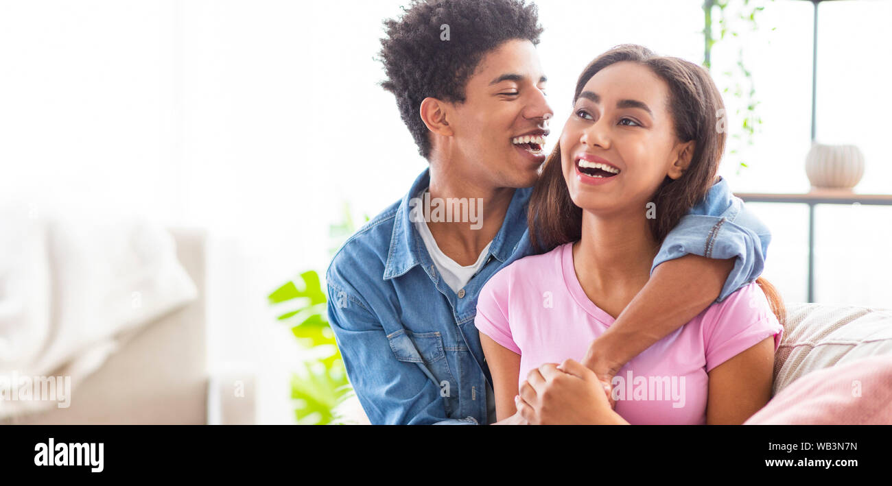 Cheerful african teenagers having date at home Stock Photo