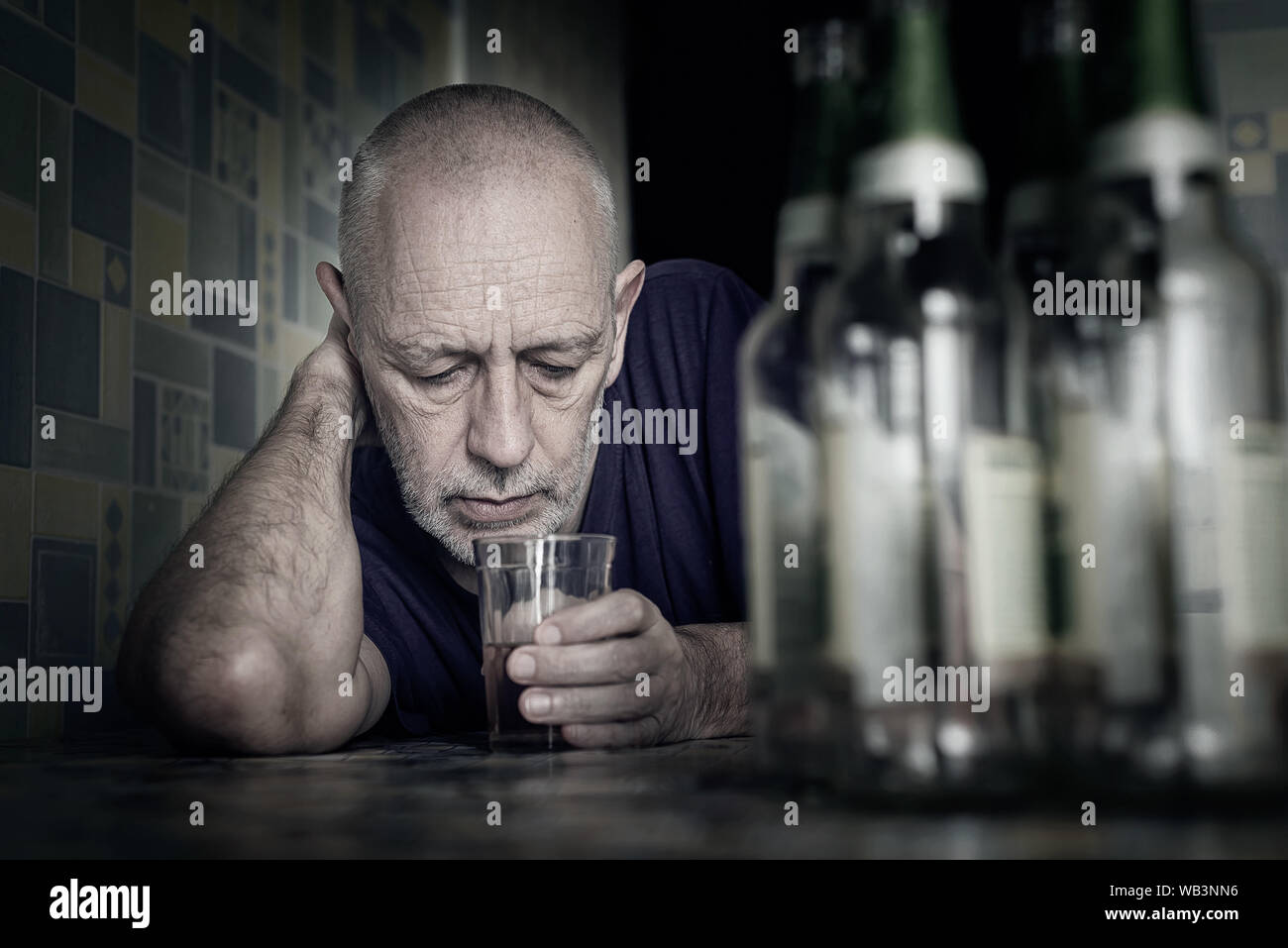 A desperate man falls into depression and becomes alcoholic and miserable. His addiction leads him to a state of loneliness and poverty. He has no hop Stock Photo
