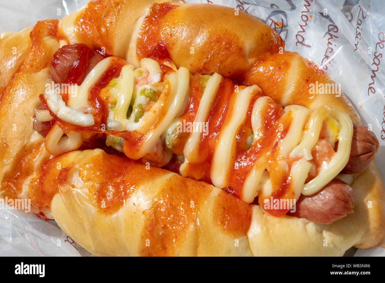 Baked hot dog served with pepperoni and sauce Stock Photo Alamy