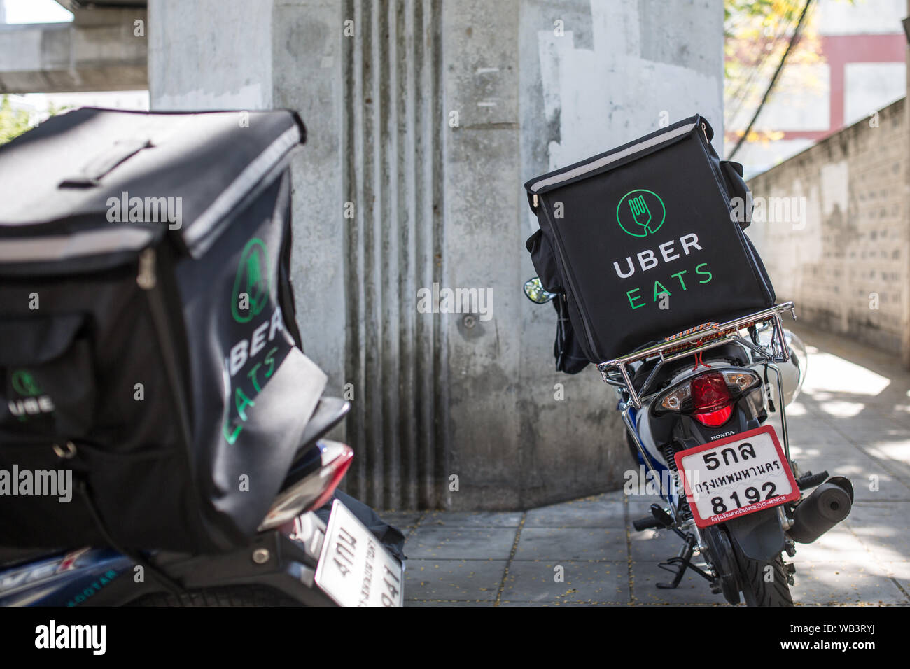 BANGKOK, THAILAND - JANUARY 27, 2017: An Uber Eats two motor scooter parked on the side of the road. Stock Photo