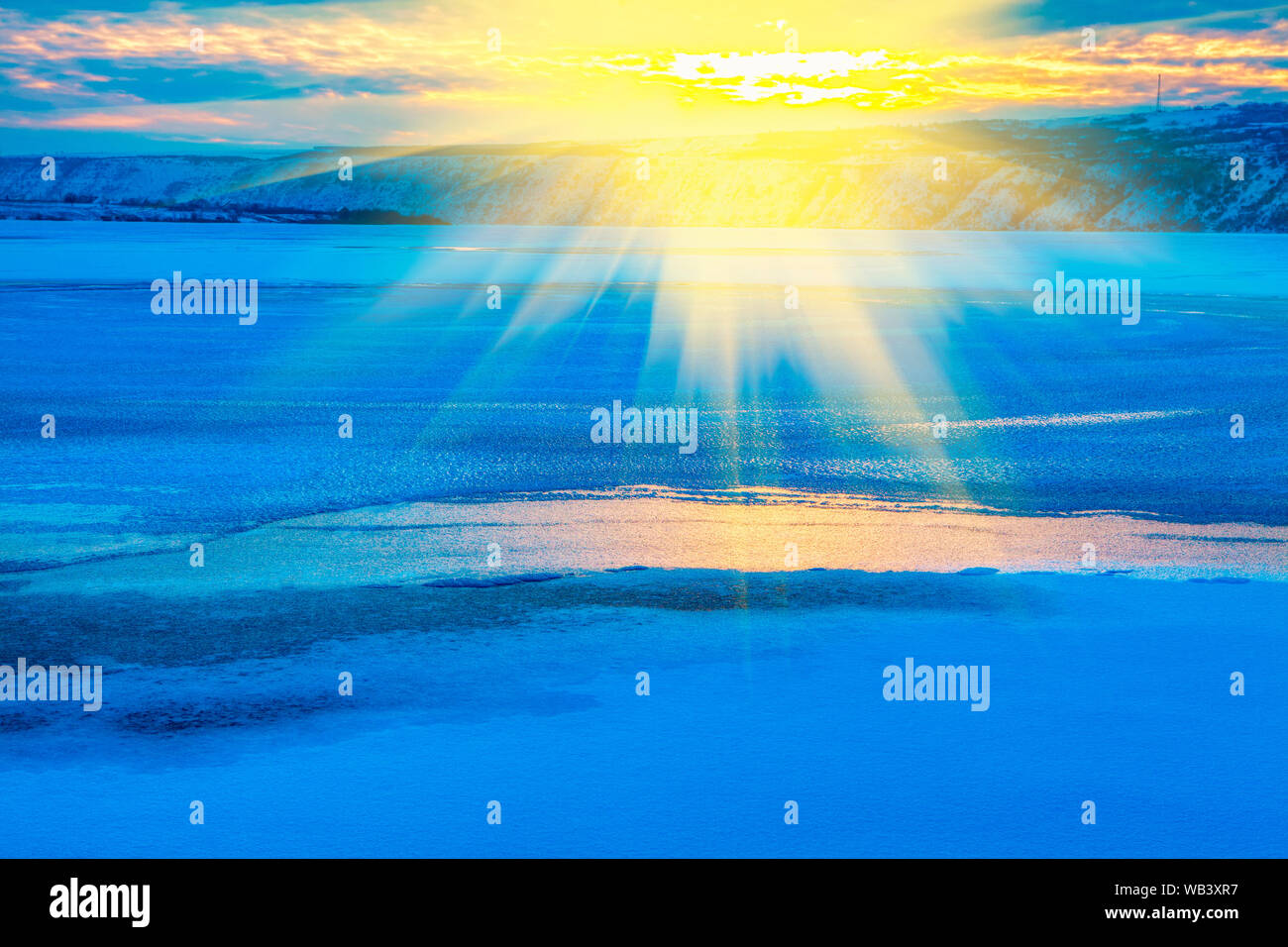 idyllic winter, scenery with sun over frozen lake Stock Photo