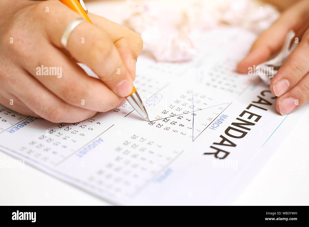 Picture of Man holding Calendar and marking on date. Isolated on white background. Stock Photo