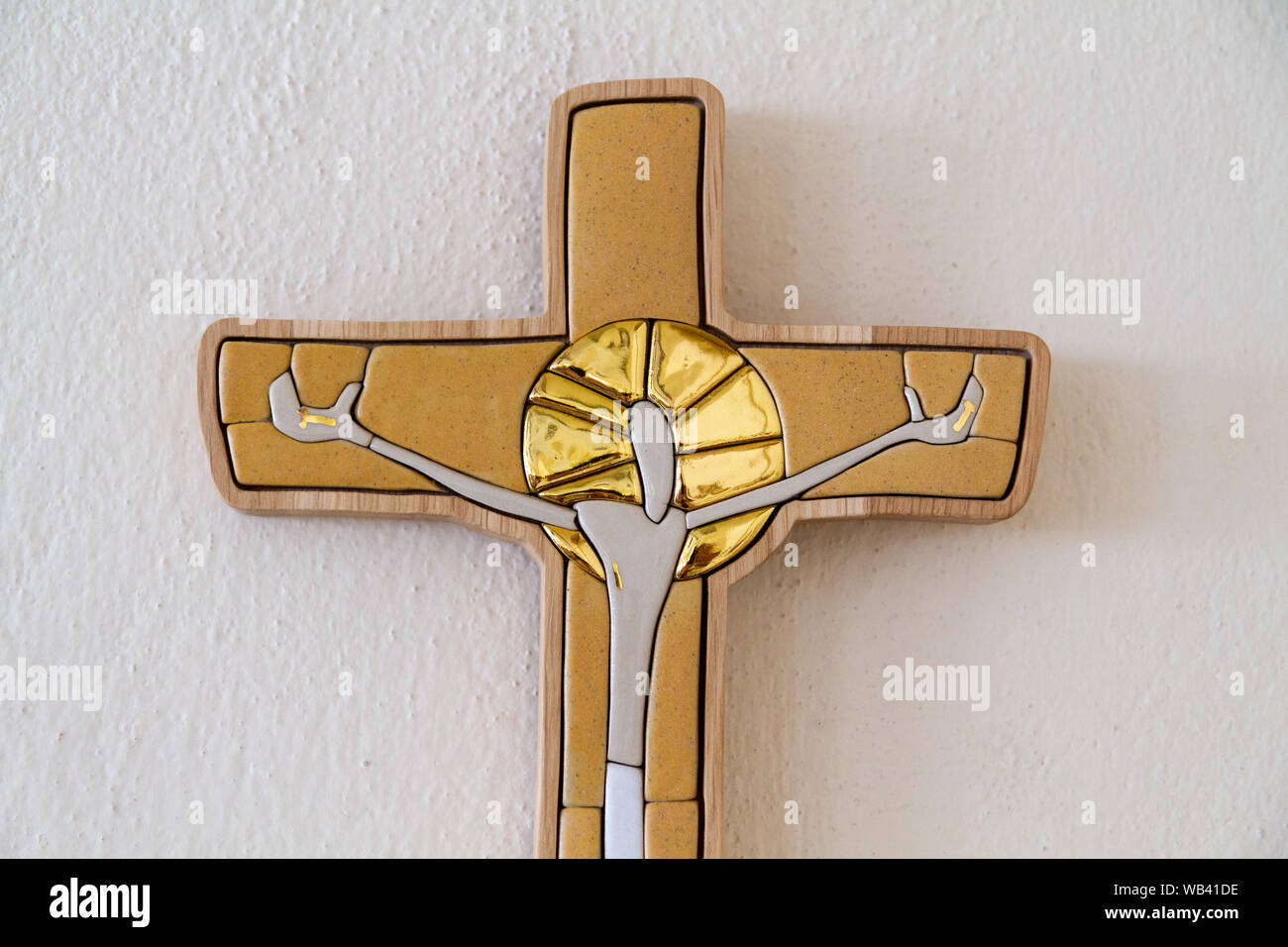 A glazed-tile mosaic of Jesus Christ in a wooden cross by Lubo Michalko. Displayed in the Quo Vadis Catholic House. Stock Photo