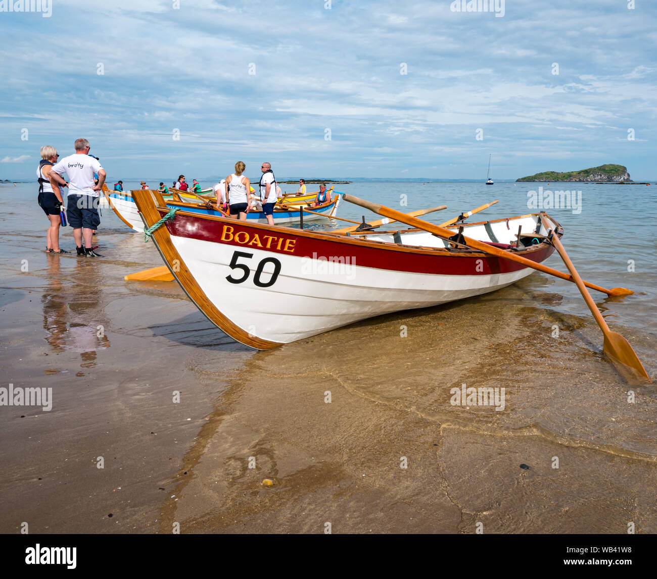 North Berwick, Scotland, UK, 24 August 2019. Colourful rowing skiffs ...