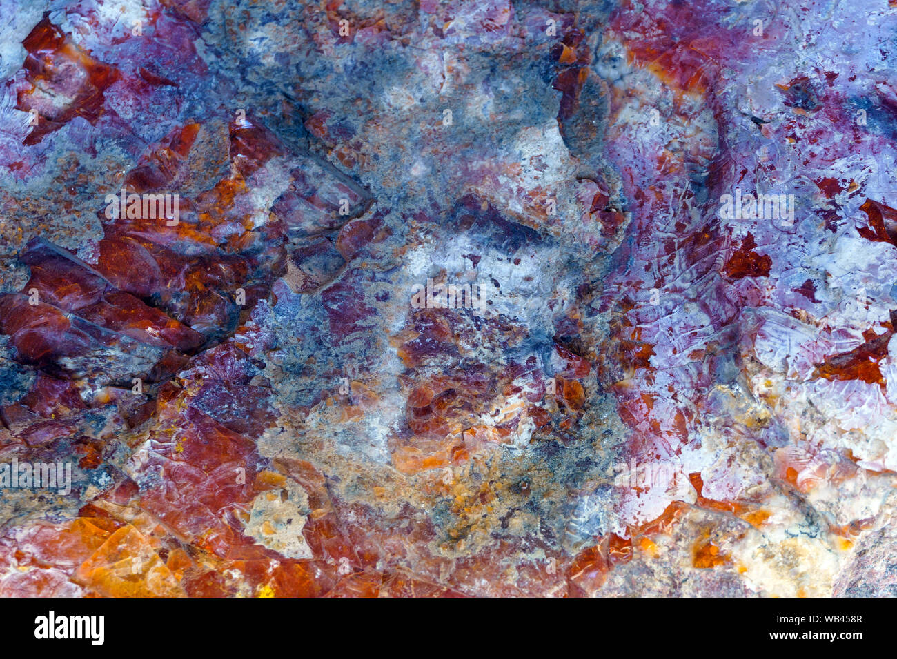 background, texture - blue-red crystalline colored natural stone surface Stock Photo