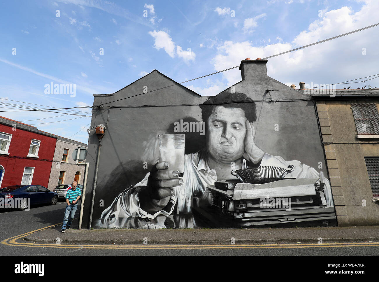 A man walks past a new mural of Irish author Brendan Behan in Richmond ...