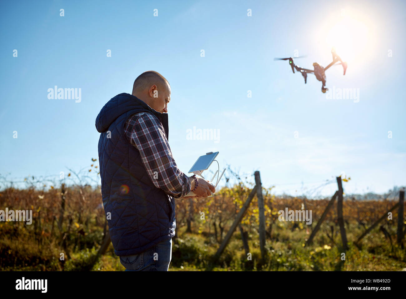 Man from ground manage drone at sky Stock Photo