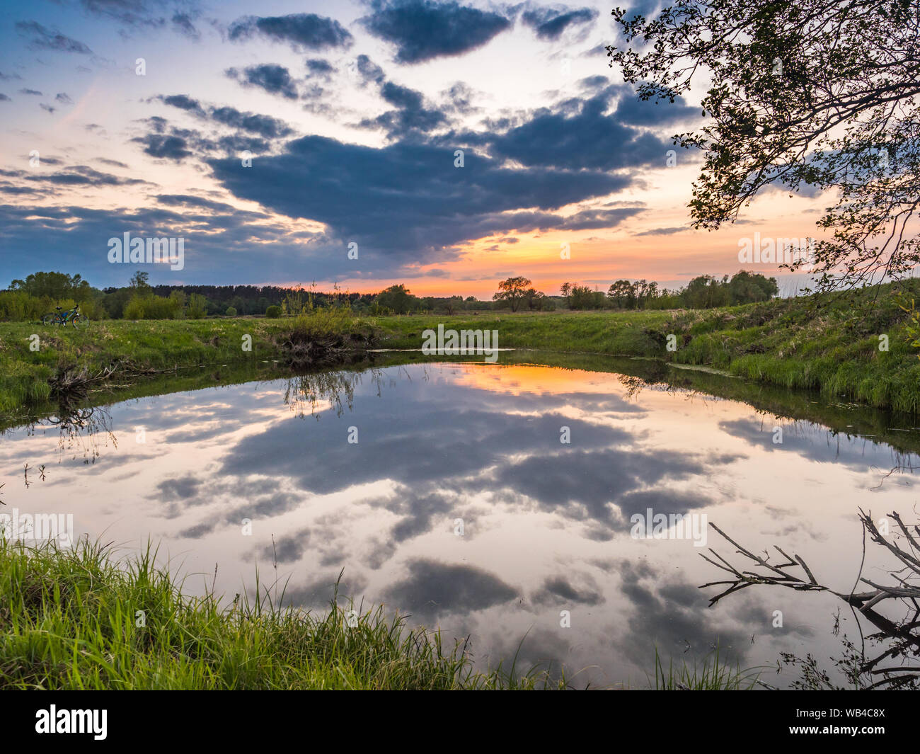 Sunset over the pond next to Bug river.  Podlasie. Podlachia. Poland, Europe. The region is called Podlasko or Podlasze. Stock Photo