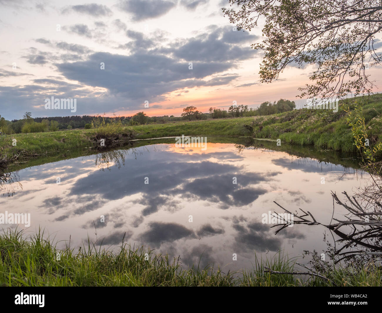 Sunset over the pond next to Bug river.  Podlasie. Podlachia. Poland, Europe. The region is called Podlasko or Podlasze. Stock Photo