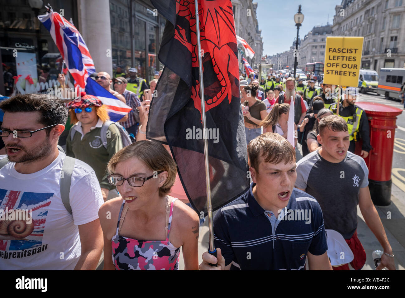 London, UK. 24th August, 2019. 'Free Tommy Robinson' protest outside BBC Broadcasting House. Police make over twenty arrests during a demonstration in support of the jailed Tommy Robinson, real name Stephen Yaxley-Lennon, who was sentenced last month to nine months in prison after being found guilty in contempt of court. Counter-protesters including antifascist activists and the anti-racist group: Stand Up to Racism, opposed the pro-Robinson demonstrators with protest groups kept apart by met police with some clashes. Credit: Guy Corbishley/Alamy Live News Stock Photo