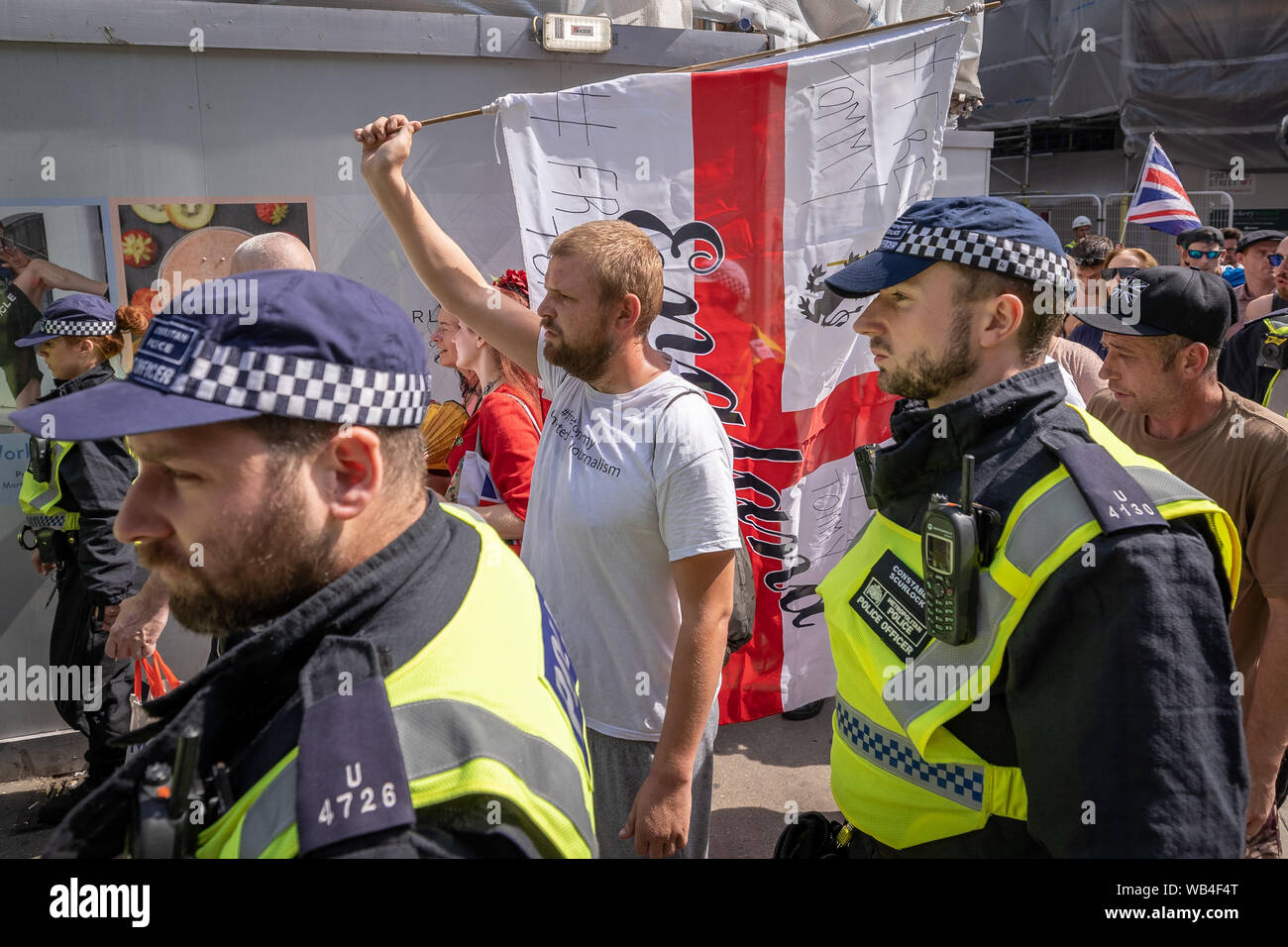 London, UK. 24th August, 2019. 'Free Tommy Robinson' protest outside BBC Broadcasting House. Police make over twenty arrests during a demonstration in support of the jailed Tommy Robinson, real name Stephen Yaxley-Lennon, who was sentenced last month to nine months in prison after being found guilty in contempt of court. Counter-protesters including antifascist activists and the anti-racist group: Stand Up to Racism, opposed the pro-Robinson demonstrators with protest groups kept apart by met police with some clashes. Credit: Guy Corbishley/Alamy Live News Stock Photo
