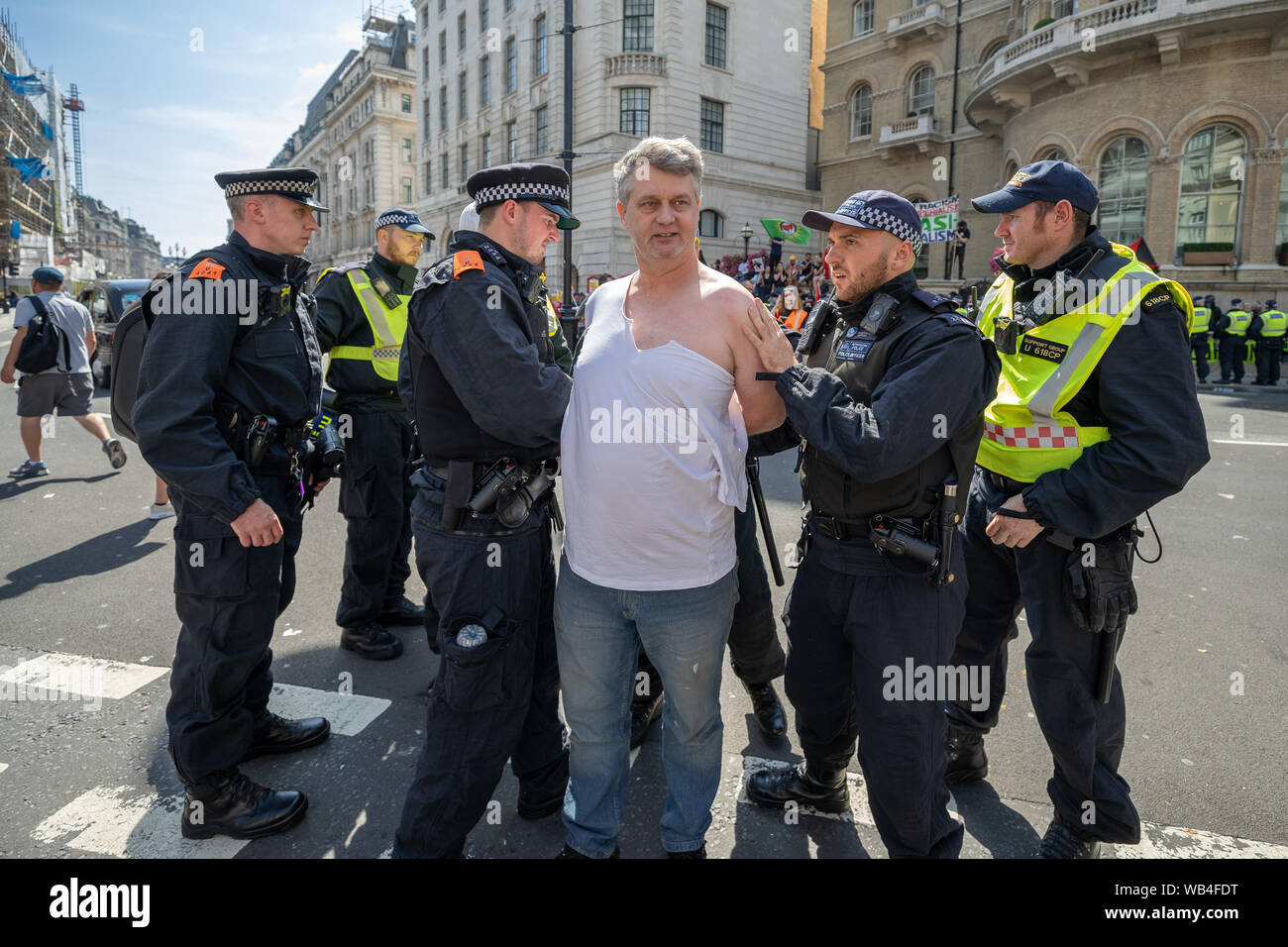 London, UK. 24th August, 2019. 'Free Tommy Robinson' protest outside BBC Broadcasting House. Police make over twenty arrests during a demonstration in support of the jailed Tommy Robinson, real name Stephen Yaxley-Lennon, who was sentenced last month to nine months in prison after being found guilty in contempt of court. Counter-protesters including antifascist activists and the anti-racist group: Stand Up to Racism, opposed the pro-Robinson demonstrators with protest groups kept apart by met police with some clashes. Credit: Guy Corbishley/Alamy Live News Stock Photo