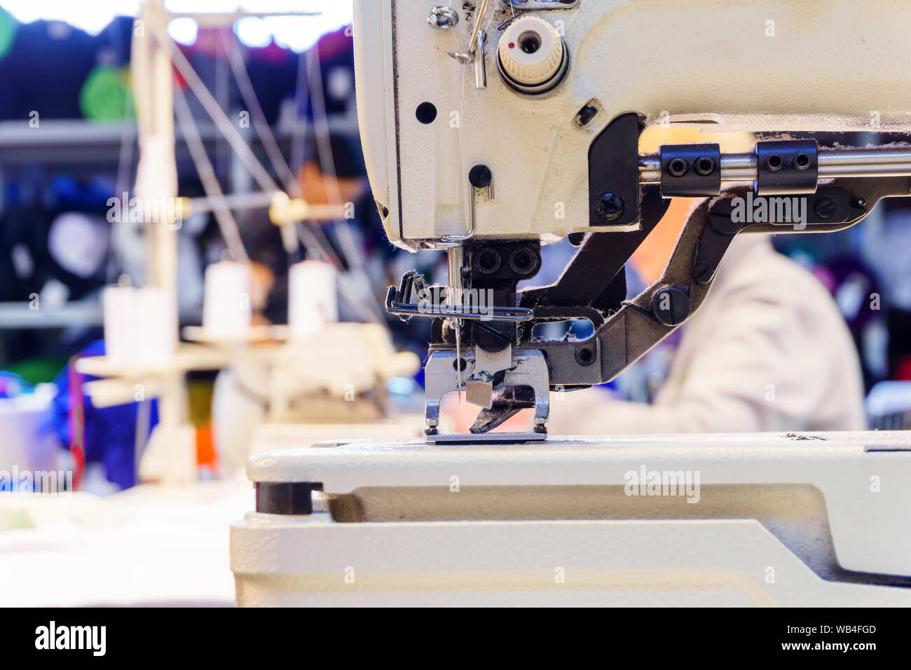 sewing mechanism of modern industrial overlock, covered with dust and