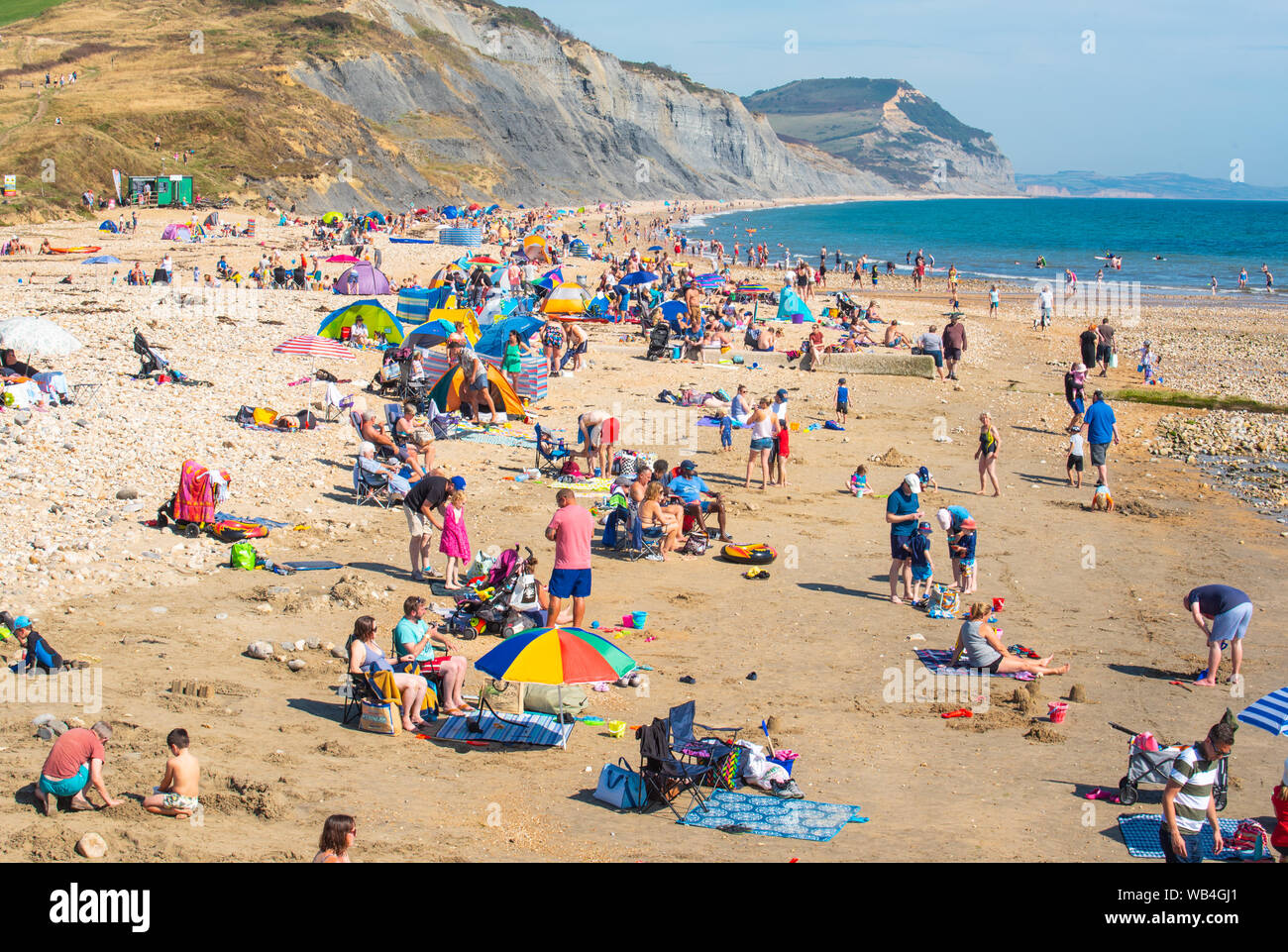 Charmouth, Dorset, UK. 24th Aug, 2019. UK Weather: The seaside village of Charmouth (Lyme Regis' quieter neighbour) was busy as sun seekers flocked to the beach to soak up the hot sunshine over the August bank holiday weekend. Credit: Celia McMahon/Alamy Live News Stock Photo